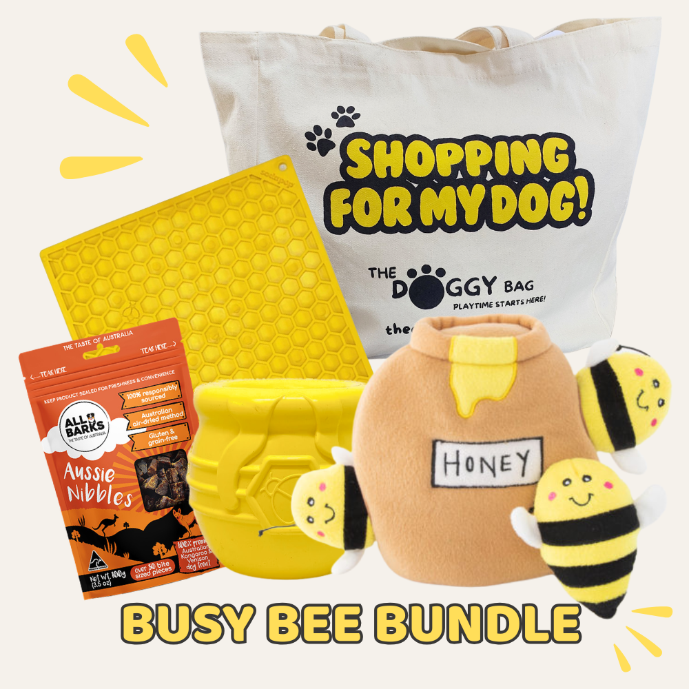 Busy Bee Bundle with 'The Doggy Bag' tote bag, honeycomb mat, and bee-themed products on a white background.