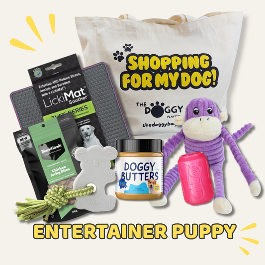 Collection of dog products including a toy, treats, and a bag with 'The Doggy Ba' branding on a white background.