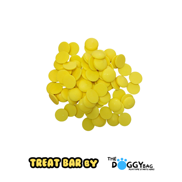 Yellow dog treats on a white background with 'Treat Bar By' and 'The Doggy Bag' logos.
